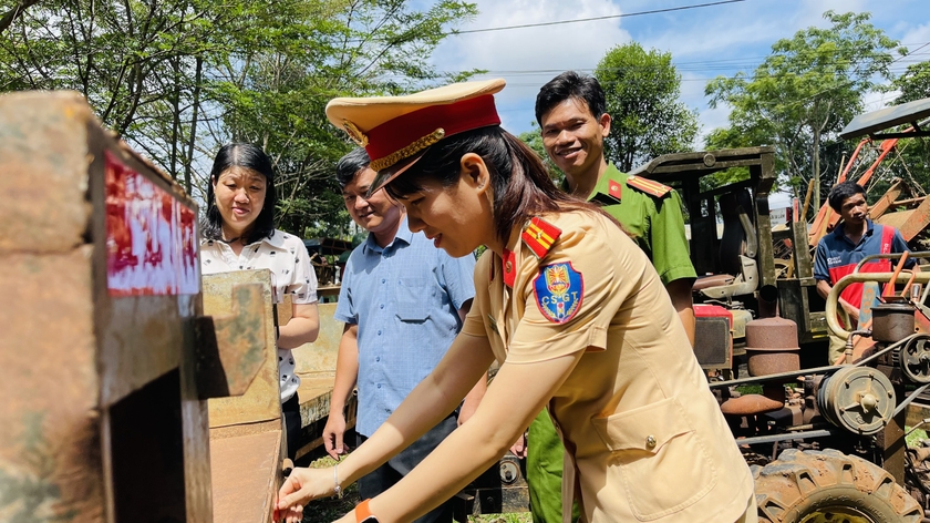 Cán bộ Công an TP. Pleiku dán phản quang cho xe công nông của người dân. Ảnh: Bá Bính