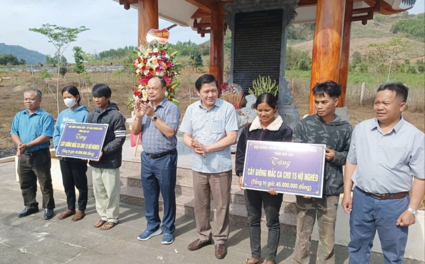 Trao bảng tượng trưng tặng giống mắc ca cho 30 hộ nghèo của xã Krong. Ảnh: Quang Tấn