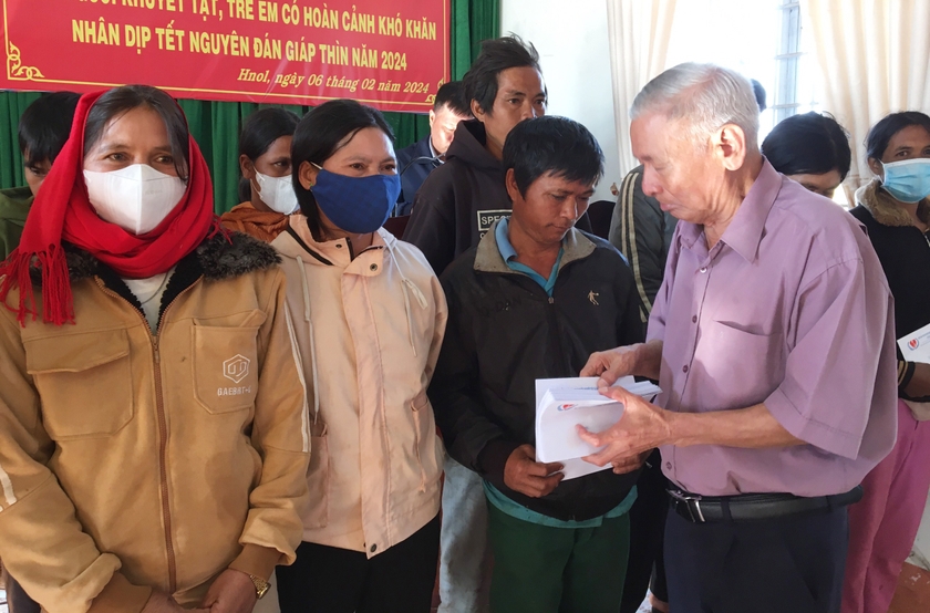 Ông Trương Đình Ba-Chủ tịch Hội Bảo trợ Người Khuyết tật và bảo vệ quyền trẻ em tỉnh Gia Lai trao quà cho các gia đình người khuyết tật tại xã Hnol, huyện Đak Đoa. Ảnh: N.P